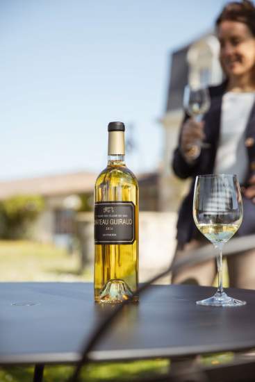 Verre et bouteille de vin blanc du <span><span><span>Château Guiraud, Visite de Château Vignoble à Sauternes</span></span></span>